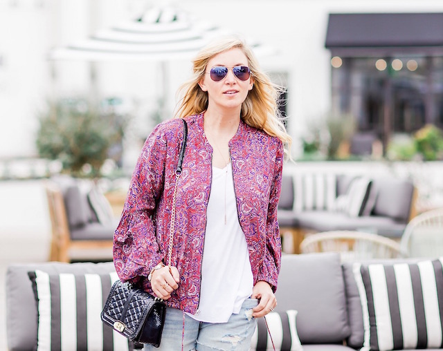 Orange County fashion blogger Nikki Prendergast of My Style Diaries wears denim cutoffs and a Free People spring bomber.