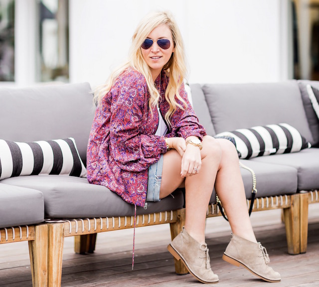 Orange County fashion blogger Nikki Prendergast of My Style Diaries wears denim cutoffs and a Free People spring bomber.