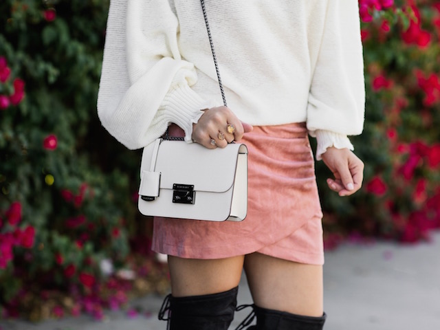 Fashion blogger Nikki Prendergast of My Style Diaries in a statement sleeve sweater, a suede skirt, and over-the-knee boots.