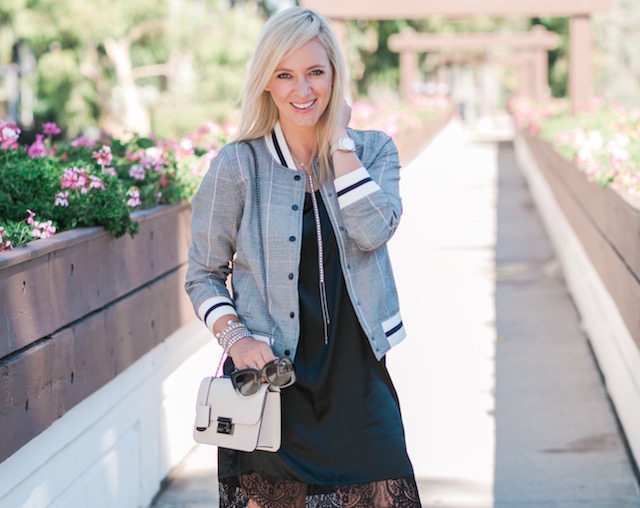 Fashion and lifestyle blogger Nikki Prendergast of My Style Diaries in a Who What Wear for TargetStyle Glen plaid bomber jacket with a Henri Bendel handbag.