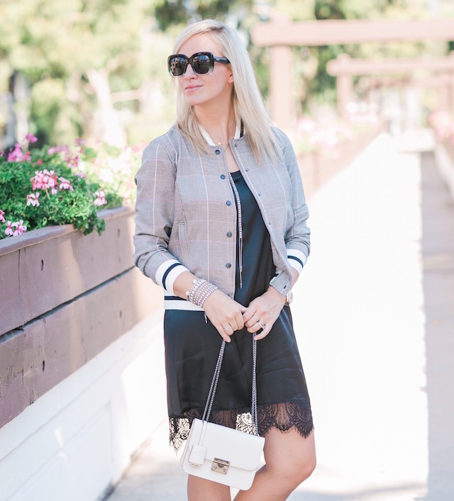 Fashion and lifestyle blogger Nikki Prendergast of My Style Diaries in a Who What Wear for TargetStyle Glen plaid bomber jacket with a Henri Bendel handbag.