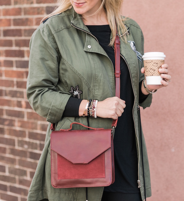 Spanx faux leather leggings, cabi jacket, crossbody bag, and Nike sneakers from Famous Footwear